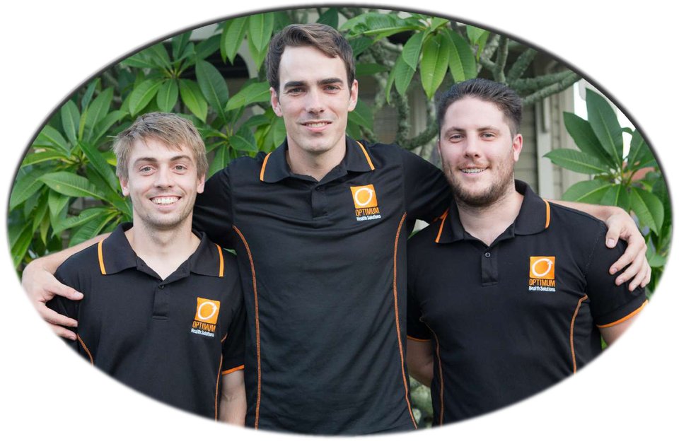 Three Optimum team members in the original Optimum Health Solutions uniforms