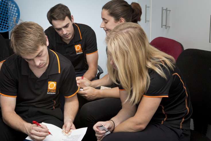 Early Optimum team members case conferencing together in the clinic