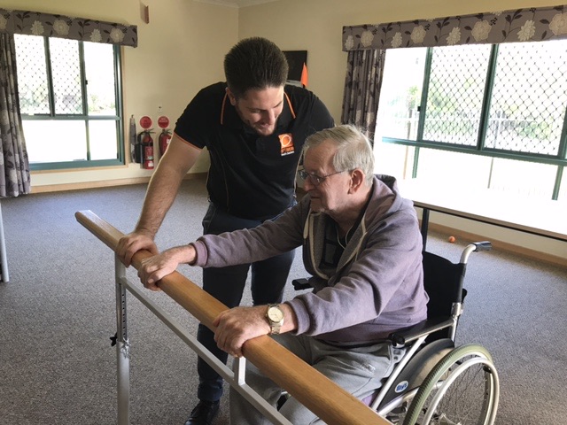 Clinician talking with a client at an Optimum Allied Health clinic