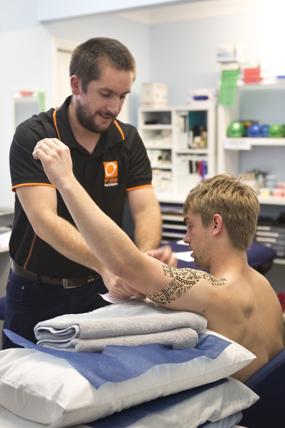 Physiotherapist applying sports tape