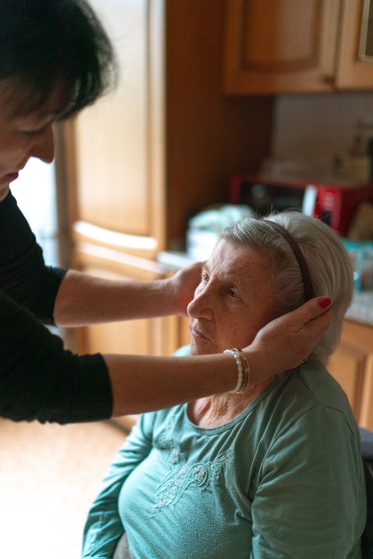 Older woman receiving care assistance at home