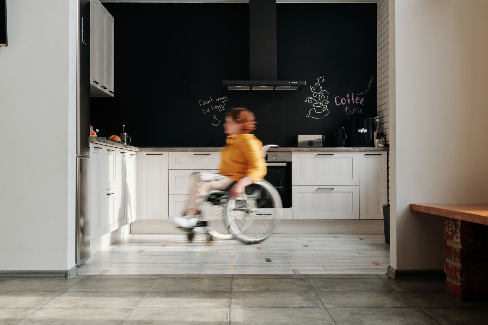 Occupational therapist assessing kitchen access with a wheelchair user